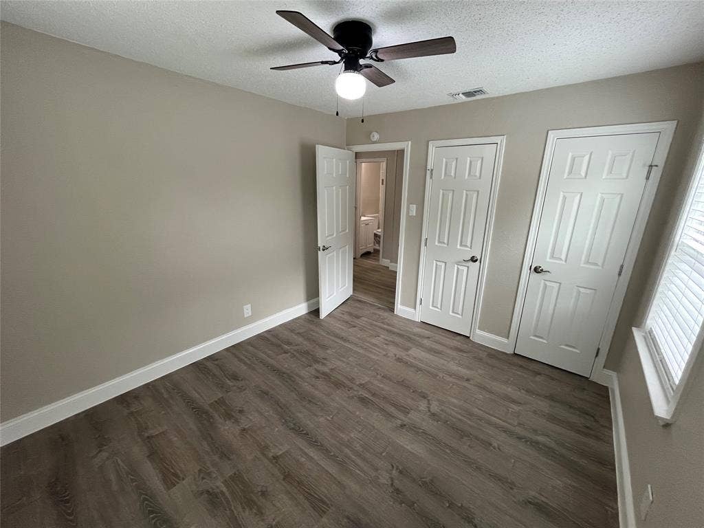 719 Fairwood Drive, Dallas, TX 75232 Room featuring wood-finish flooring, neutral wall tones, and a ceiling fan with light fixture