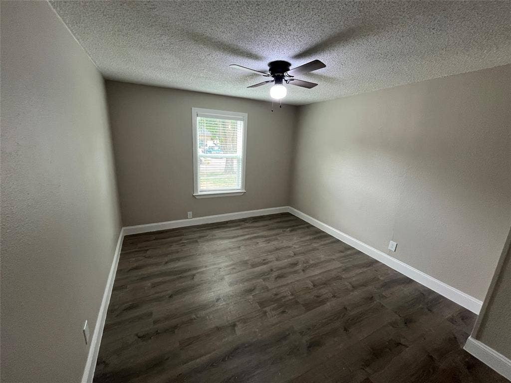 719 Fairwood Drive, Dallas, TX 75232 Bedroom featuring wood-finish flooring, neutral wall tones, a window with blinds, white baseboards, and a ceiling fan with integrated lighting
