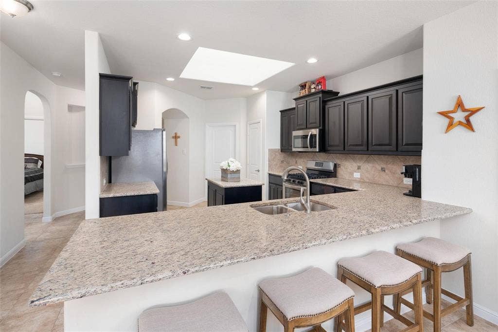 The photos were taken while the home was occupied. The furniture shown in the photos is for staging purposes only and is not included with the sale of the home.