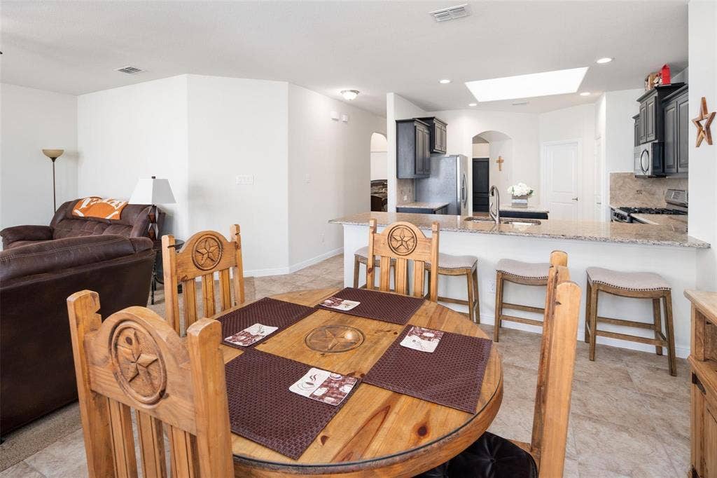 The photos were taken while the home was occupied. The furniture shown in the photos is for staging purposes only and is not included with the sale of the home.