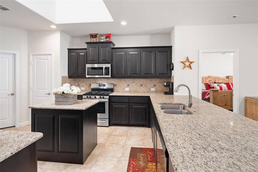 The photos were taken while the home was occupied. The furniture shown in the photos is for staging purposes only and is not included with the sale of the home.