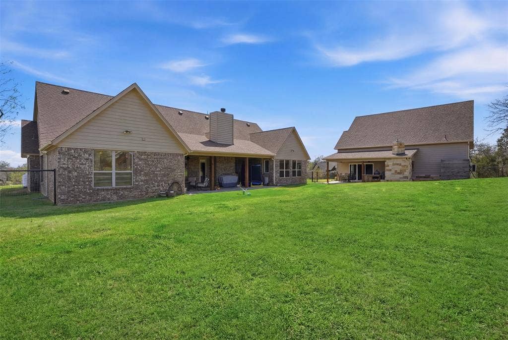 3832 Legend Trail, Granbury, TX 76049 Back of house shares yard with Accessory Dwelling Unit.