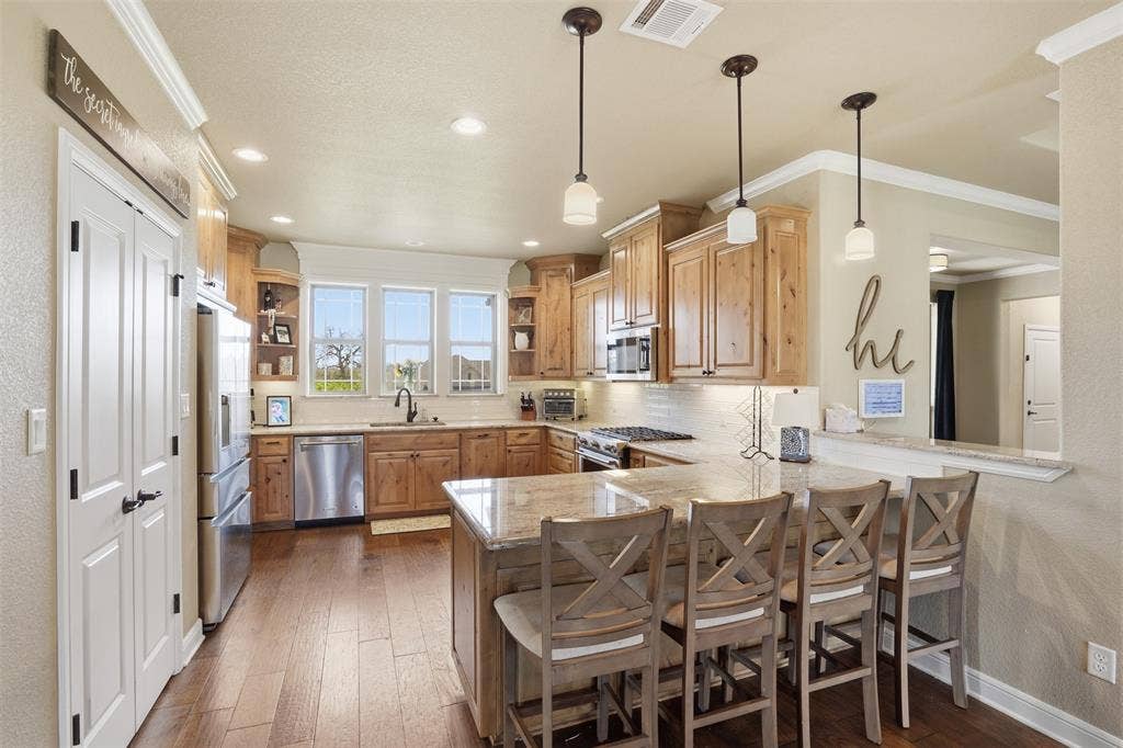3832 Legend Trail, Granbury, TX 76049 Open and inviting kitchen with wonderful breakfast bar.