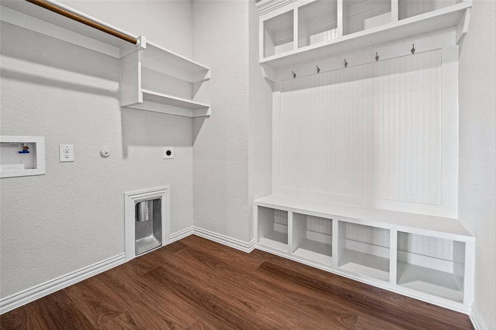 10008 Birchpoint Drive, Fort Worth, TX 76108 Wood-finish flooring, white built-in shelving, white beadboard accent wall, white built-in bench with cubbies, and garment rod
