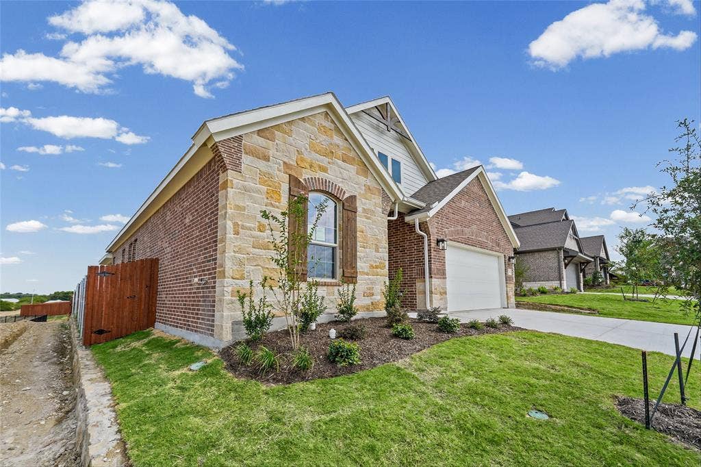 10008 Birchpoint Drive, Fort Worth, TX 76108 Stone and brick exterior with white trim and a white garage door