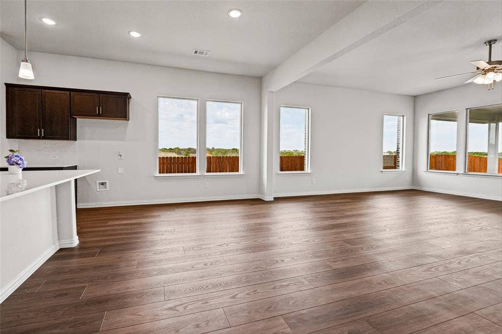 10008 Birchpoint Drive, Fort Worth, TX 76108 Expansive room with wood-finish flooring, white walls, recessed lighting, and multiple windows