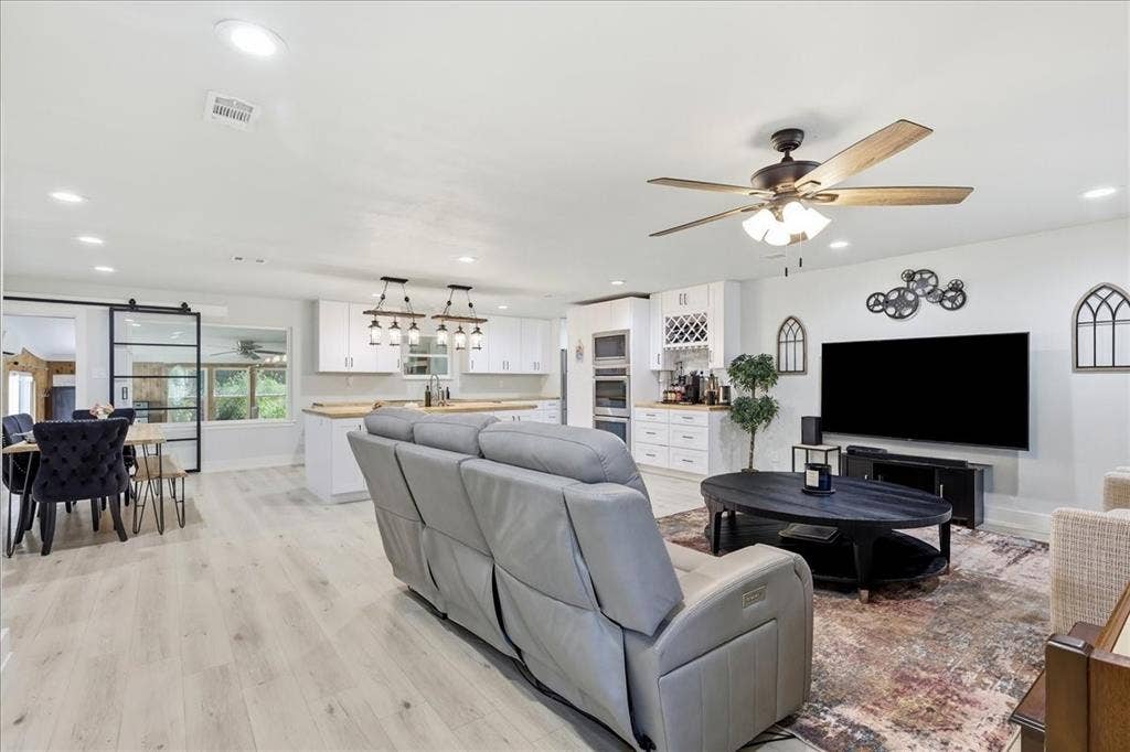 3533 Granada Drive, Richland Hills, TX 76118 the spacious living room opens to the kitchen and dining area.