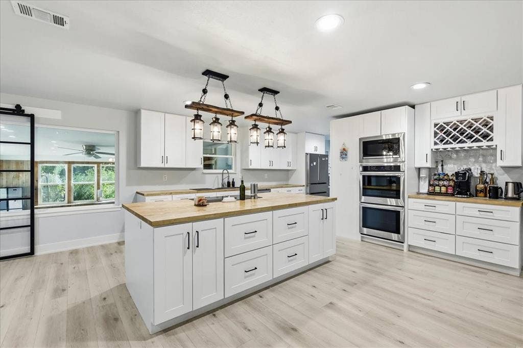 3533 Granada Drive, Richland Hills, TX 76118 large butcher block island, tons of cabinets, and a built in coffee bar nook.