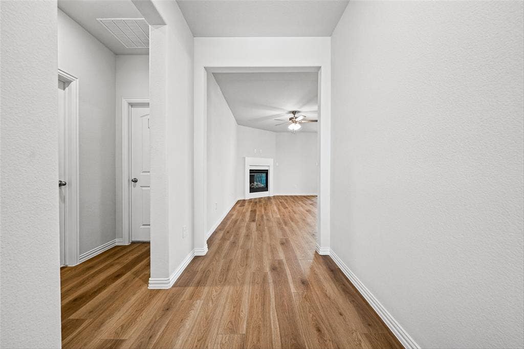 10004 Birchpoint Drive, Fort Worth, TX 76108 Wood-finish flooring throughout, white interior doors, and white baseboards