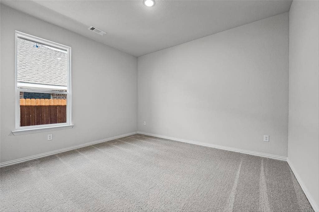 10004 Birchpoint Drive, Fort Worth, TX 76108 Spacious room featuring neutral carpeting, a large window, and recessed lighting