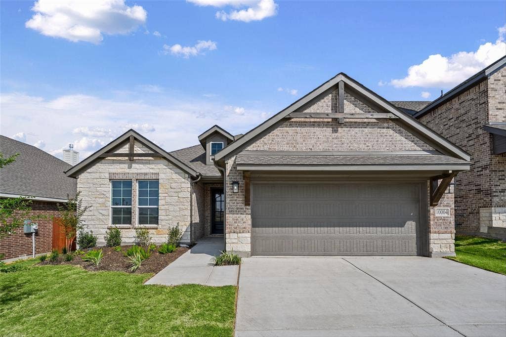 10004 Birchpoint Drive, Fort Worth, TX 76108 Stone and brick exterior with a two-car garage