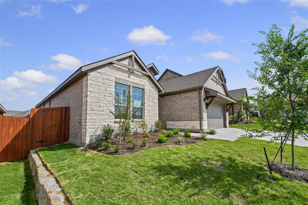 10004 Birchpoint Drive, Fort Worth, TX 76108 Stone and brick exterior with a gabled roofline