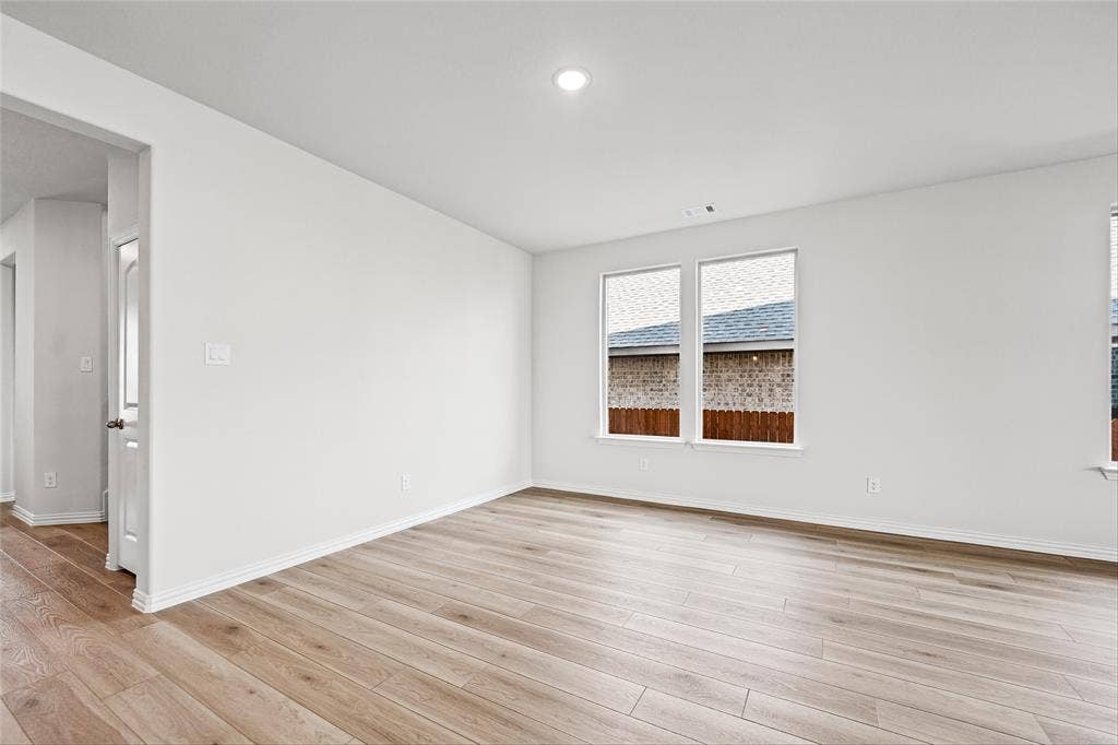 10000 Birchpoint Drive, Fort Worth, TX 76108 Wood-finish flooring, white walls, recessed lighting, and dual windows