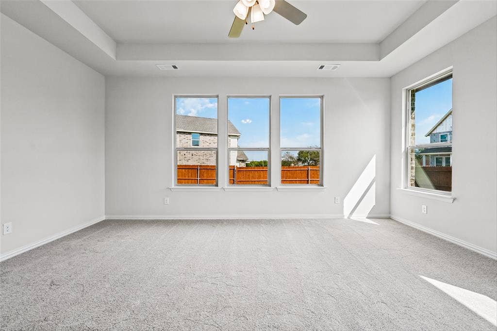 10000 Birchpoint Drive, Fort Worth, TX 76108 Recessed ceiling featuring a ceiling fan, light gray carpeting, and multiple windows