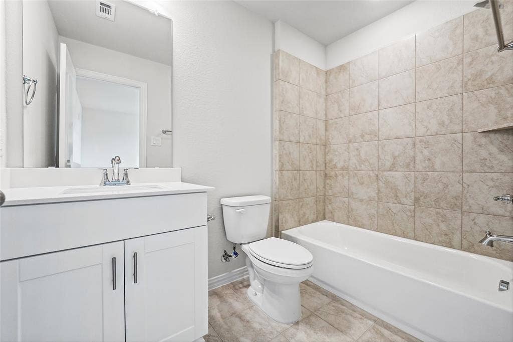10000 Birchpoint Drive, Fort Worth, TX 76108 Bathroom featuring a white vanity with integrated sink, chrome faucet, and a large wall-mounted mirror