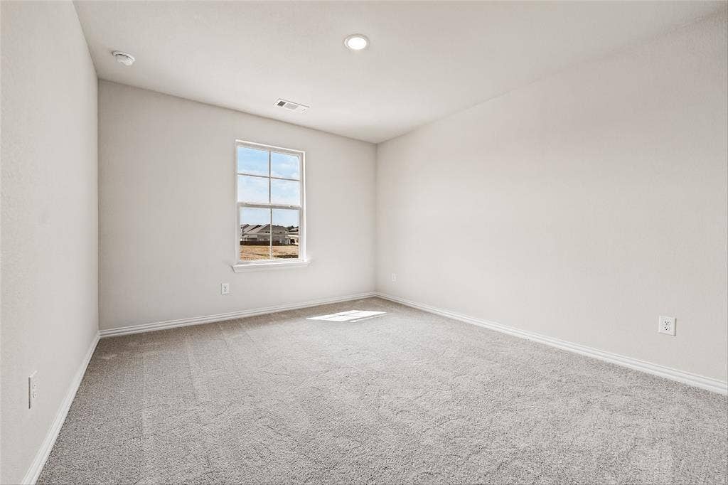 10000 Birchpoint Drive, Fort Worth, TX 76108 Recessed lighting, light gray carpeting, and a window with a white frame
