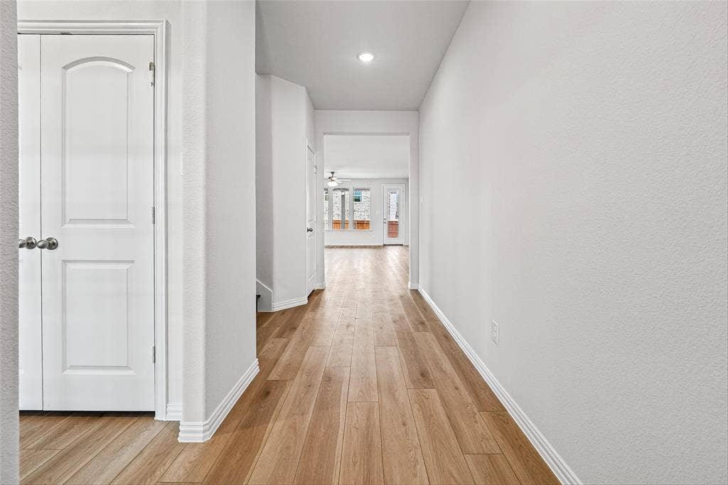 10000 Birchpoint Drive, Fort Worth, TX 76108 Recessed lighting, wood-finish flooring, white paneled door, and neutral wall finish