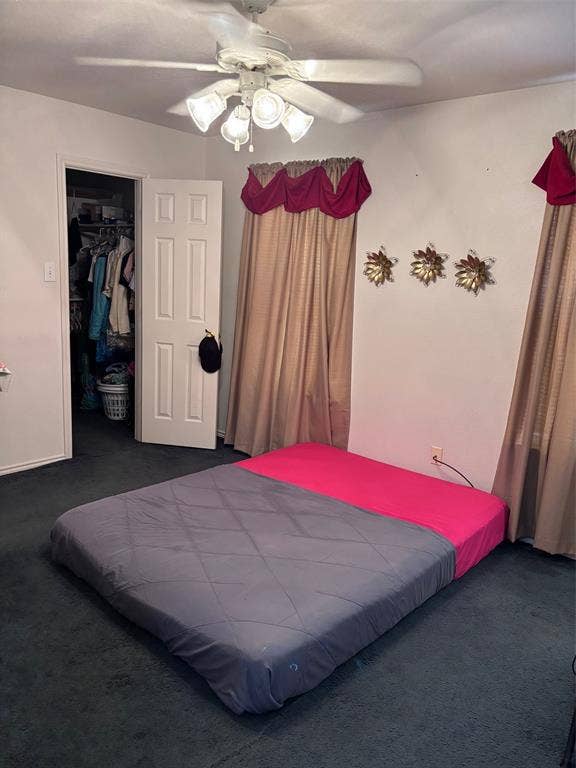 9656 Stonewood Drive, Dallas, TX 75227 Carpeted room featuring a ceiling fan with integrated lighting, a white panel door, and an open closet