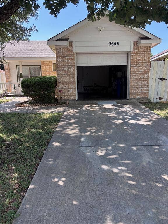 9656 Stonewood Drive, Dallas, TX 75227 Brick and siding exterior featuring a single-car garage with an overhead door
