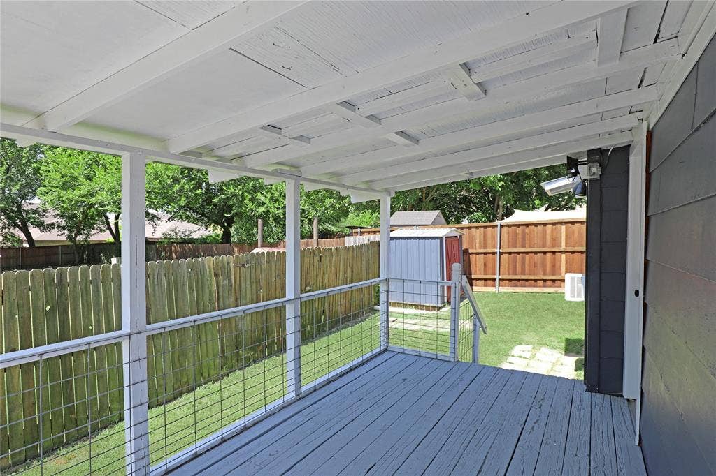 1201 1/2 Cole Street, McKinney, TX 75069 Covered deck with painted wood flooring and white support posts