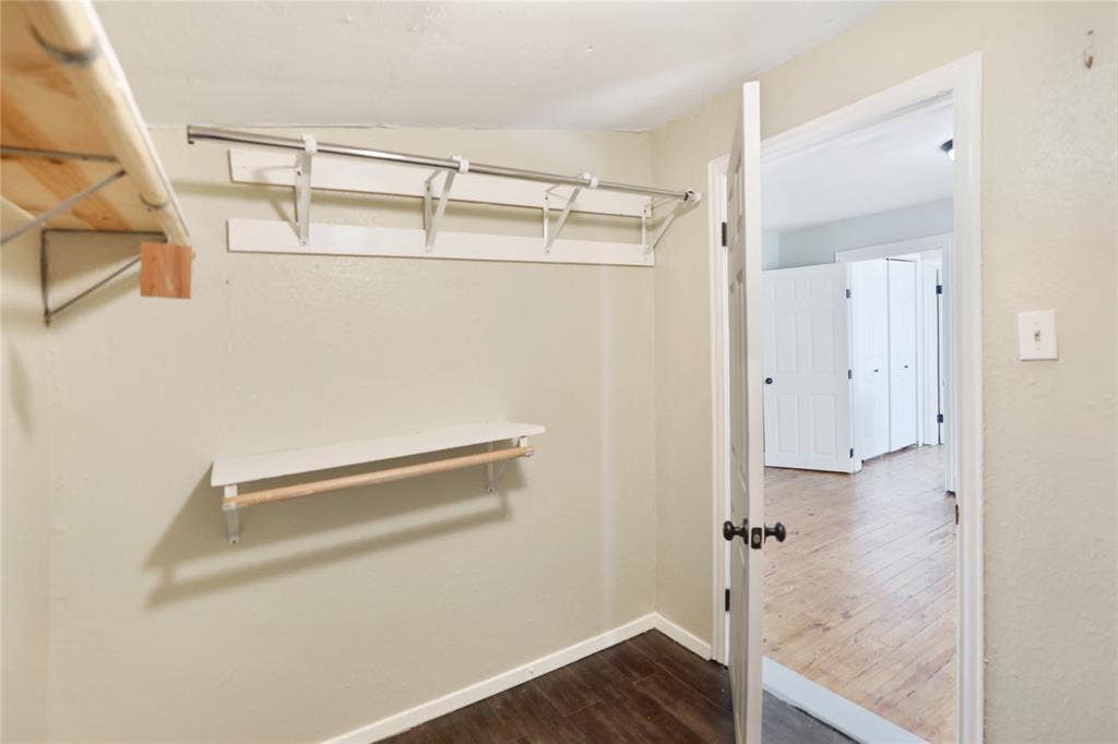1201 1/2 Cole Street, McKinney, TX 75069 Built-in closet shelving and hanging rods with wood-finish flooring