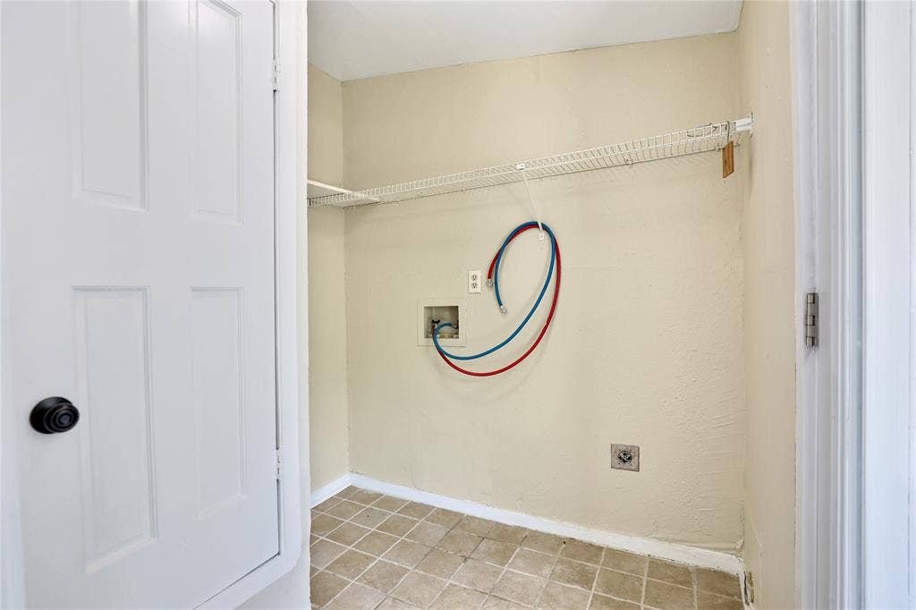 1201 1/2 Cole Street, McKinney, TX 75069 Dedicated utility area featuring a tiled floor, neutral wall paint, and integrated wire shelving