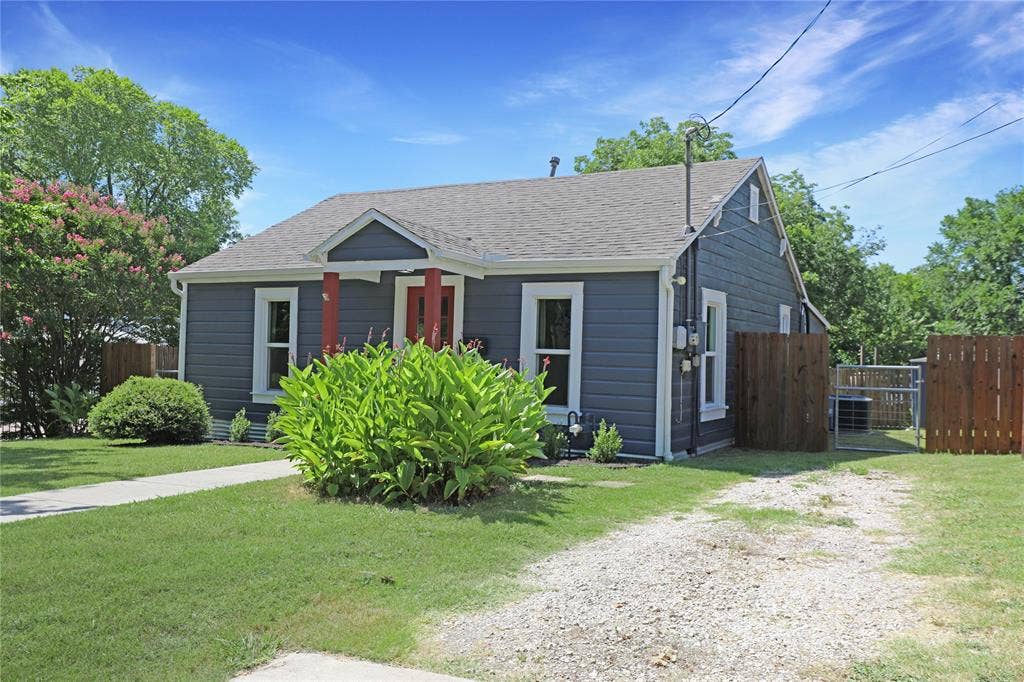 1201 1/2 Cole Street, McKinney, TX 75069 Charming bungalow exterior featuring horizontal siding, a gabled roofline, and a covered entry with red columns