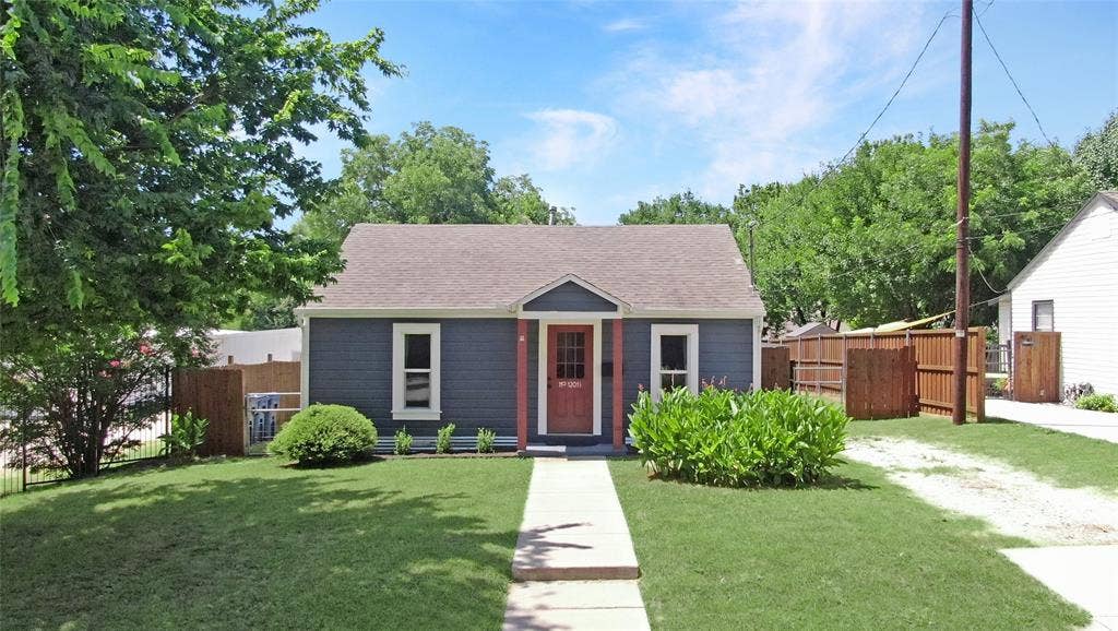 1201 1/2 Cole Street, McKinney, TX 75069 Single-story home featuring a dark blue siding exterior with white trim and a brown front door