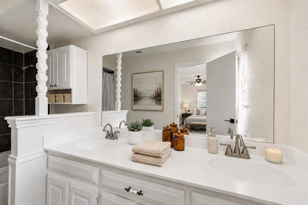 3624 Churchill Lane, Plano, TX 75075 The refreshed primary bath features painted cabinetry, resurfaced countertops, updated flooring and a bright, cohesive finish palette.Virtually Staged -- original image may have been altered by AI.
