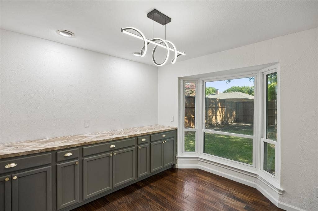 3624 Churchill Lane, Plano, TX 75075 Custom cabinetry creates a functional serving area while preserving ample room for a full dining table.