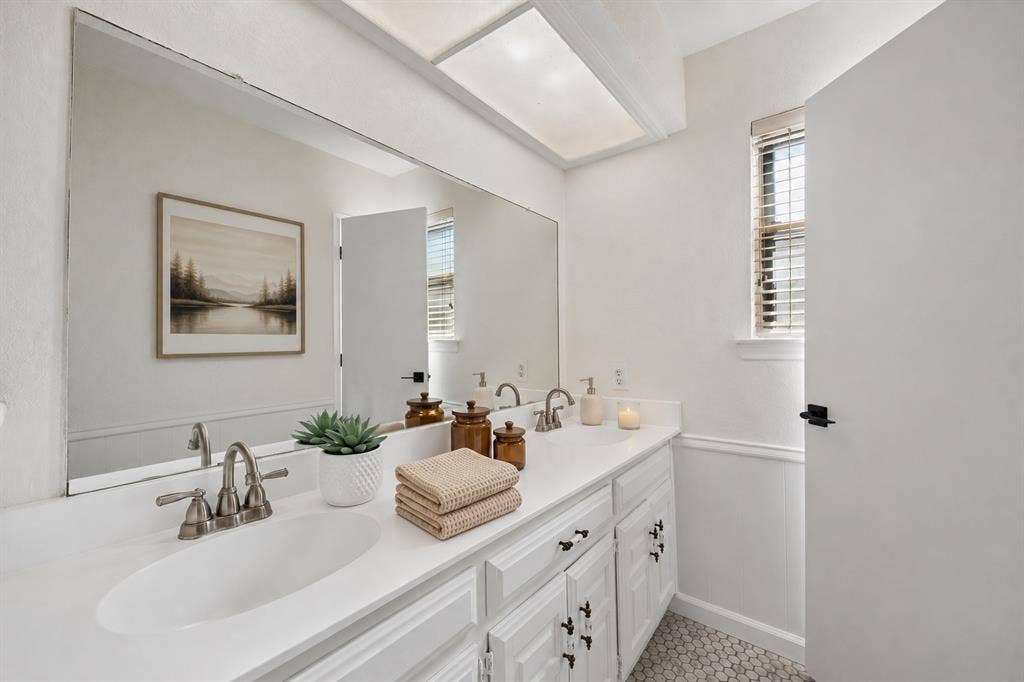 3624 Churchill Lane, Plano, TX 75075 Dual sinks and generous vanity storage support comfortable daily routines in the thoughtfully refreshed primary bathroom.Virtually Staged -- original image may have been altered by AI.