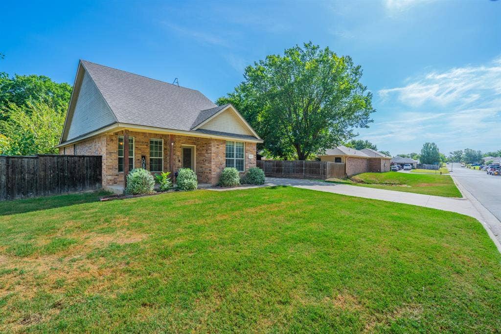 403 Summer Tree Lane, Springtown, TX 76082 Brick exterior with a dark shingle roof and a prominent front gable