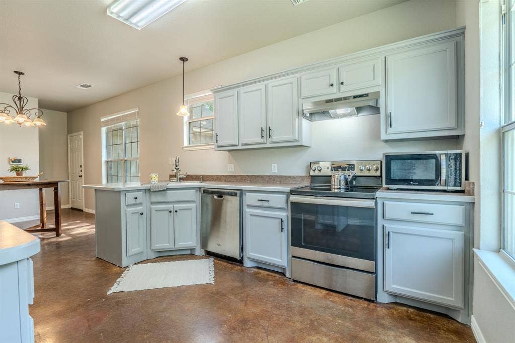 403 Summer Tree Lane, Springtown, TX 76082 Kitchen featuring stainless steel dishwasher, stove and microwave