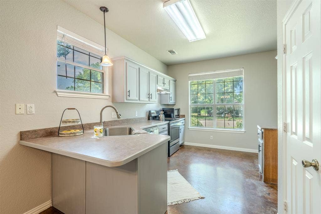 403 Summer Tree Lane, Springtown, TX 76082 Kitchen featuring light cabinetry, natural lighting and fresh paint