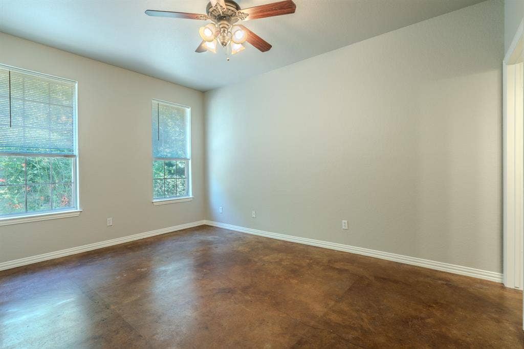 403 Summer Tree Lane, Springtown, TX 76082 Primary bedroom featuring a ceiling fan, fresh paint and stained concrete flooring