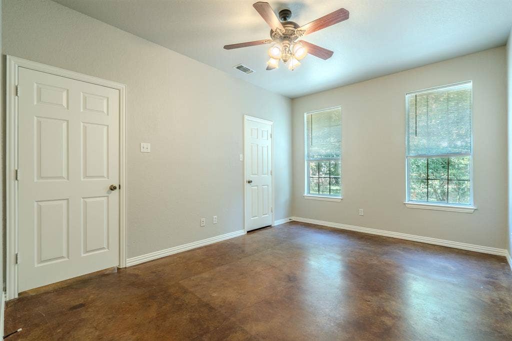 403 Summer Tree Lane, Springtown, TX 76082 Primary bedroom featuring a ceiling fan, fresh paint and stained concrete flooring
