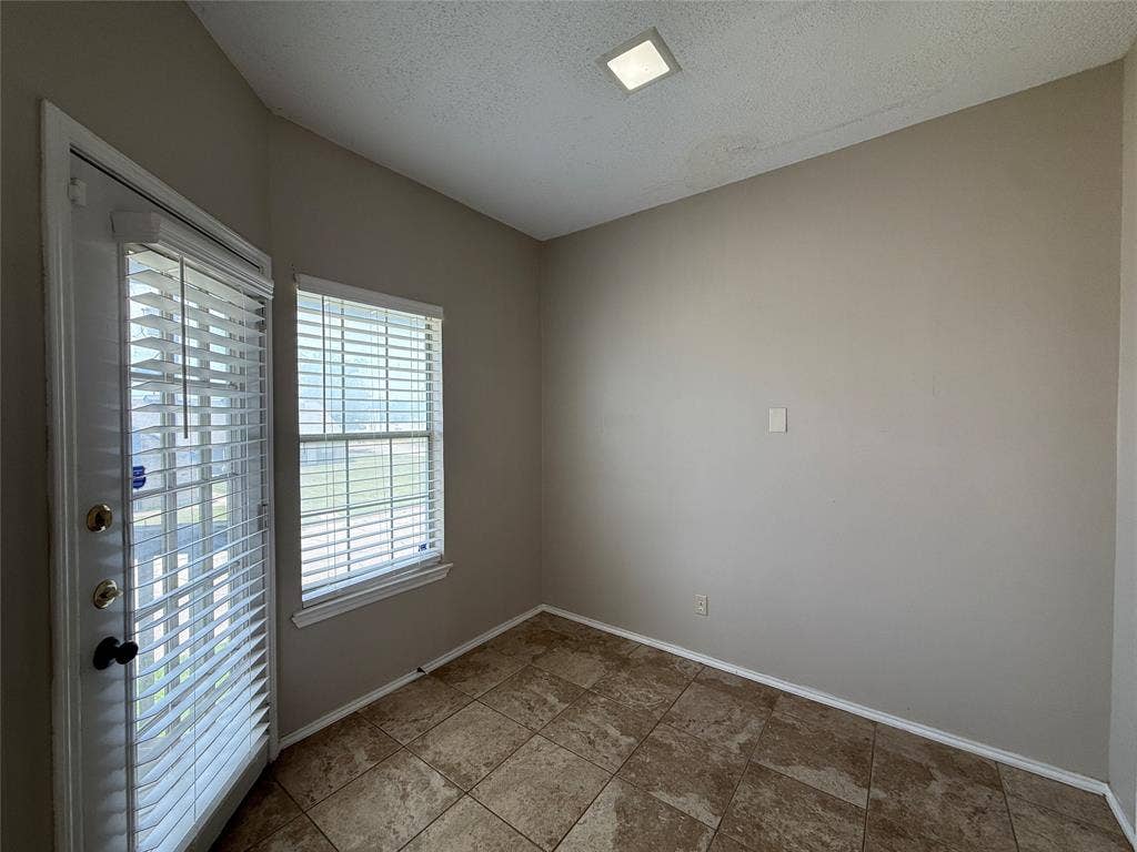 Spare room with a textured ceiling