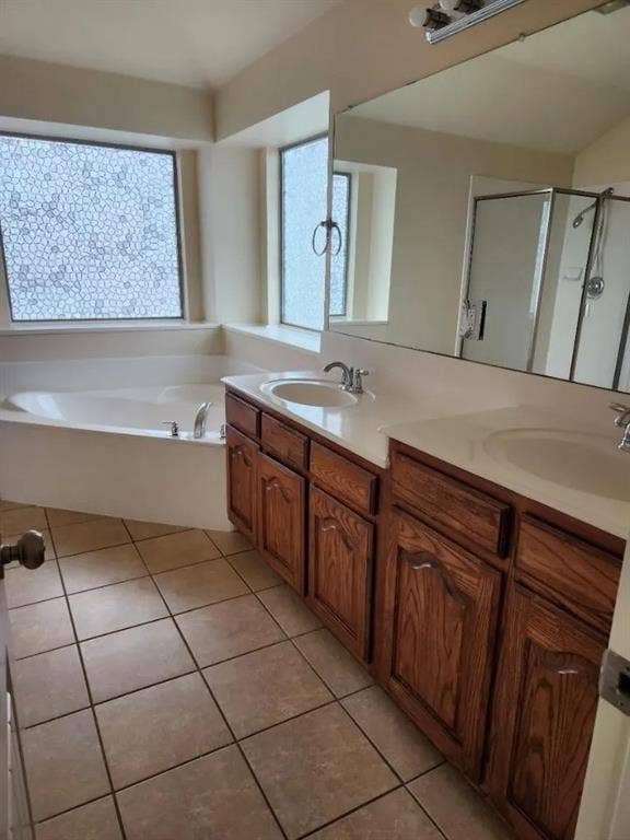 1214 Alabama Court, Murphy, TX 75094 Bathroom featuring an integrated soaking tub, dual vanity with wood cabinetry, and a full-width mirror