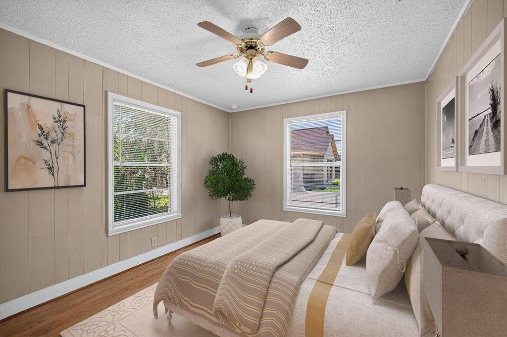 4450 Percy Street, Lancaster, TX 75134 Room featuring wood-finish flooring, vertical paneling, and white trim