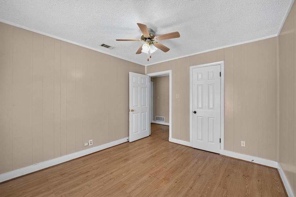 4450 Percy Street, Lancaster, TX 75134 Room featuring light wood-finish flooring and paneled walls