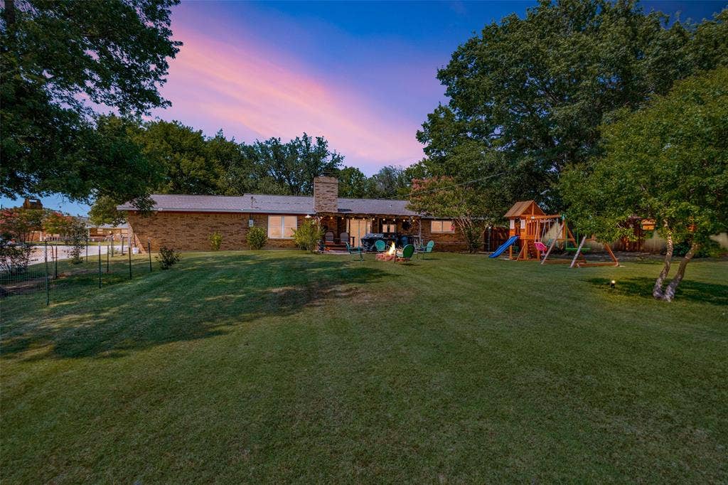 906 Clearview Street, Krum, TX 76249 Expansive backyard featuring a lush lawn and mature trees