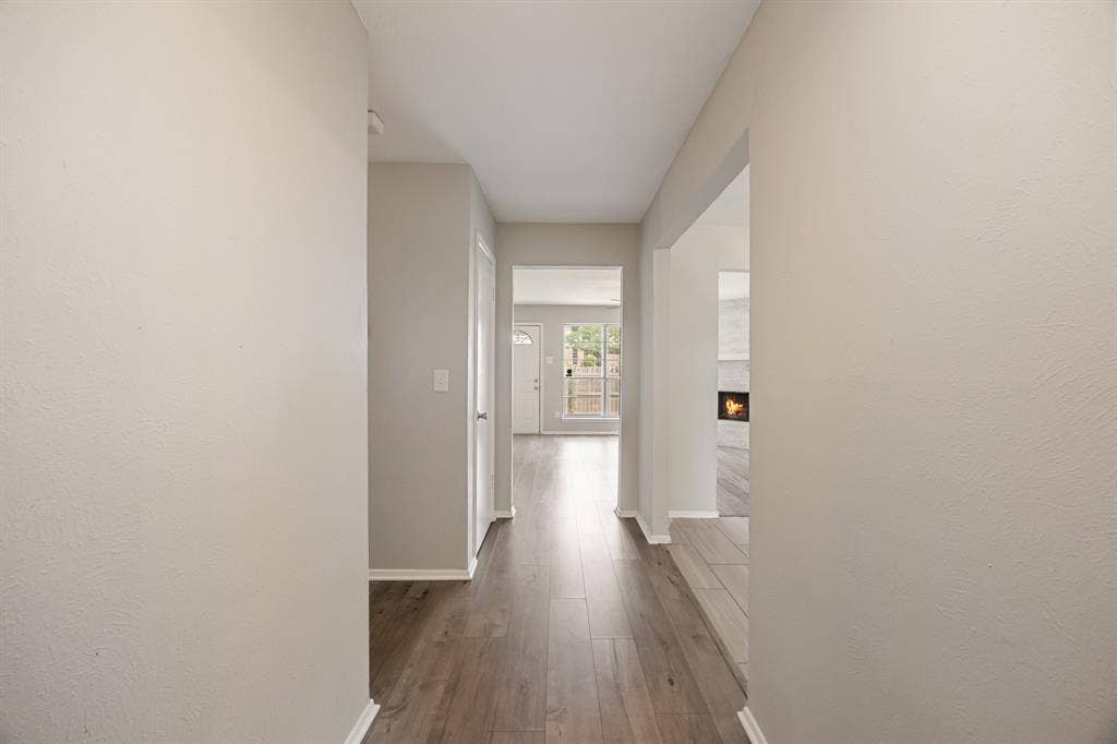 1 E Mountain Lane, #33, Grand Prairie, TX 75052 Hallway featuring wood-finish flooring, light neutral wall paint, white trim, and recessed lighting