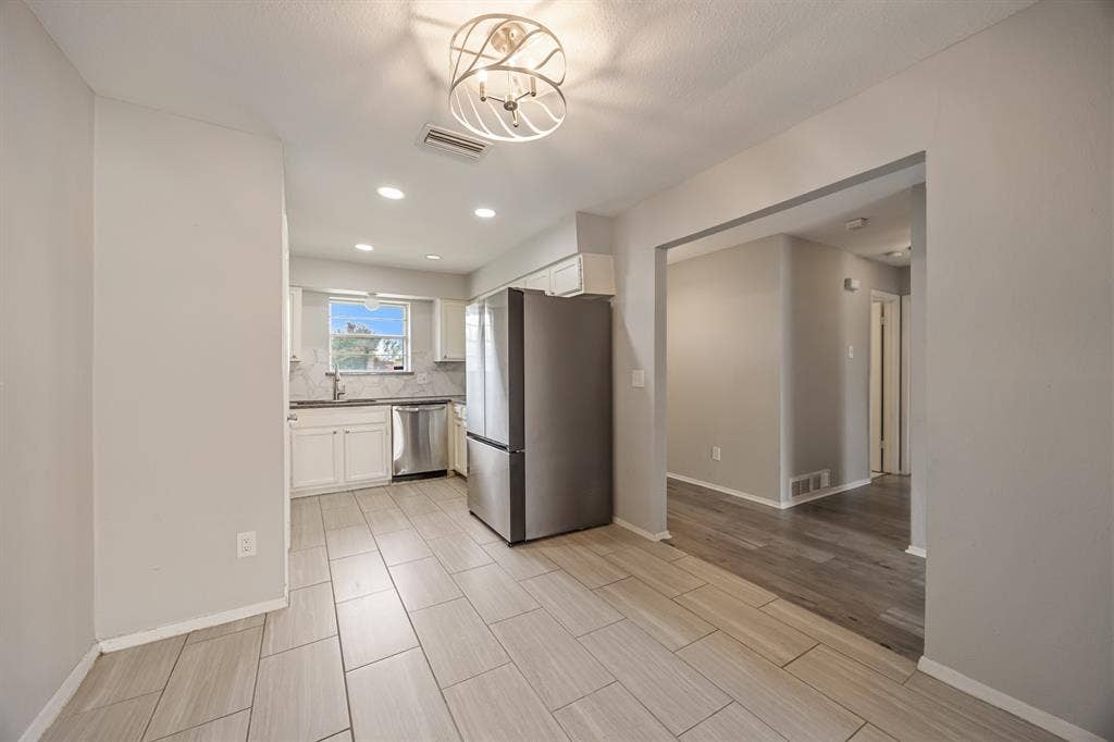 1 E Mountain Lane, #33, Grand Prairie, TX 75052 Open concept kitchen and dining area featuring light-toned tile flooring