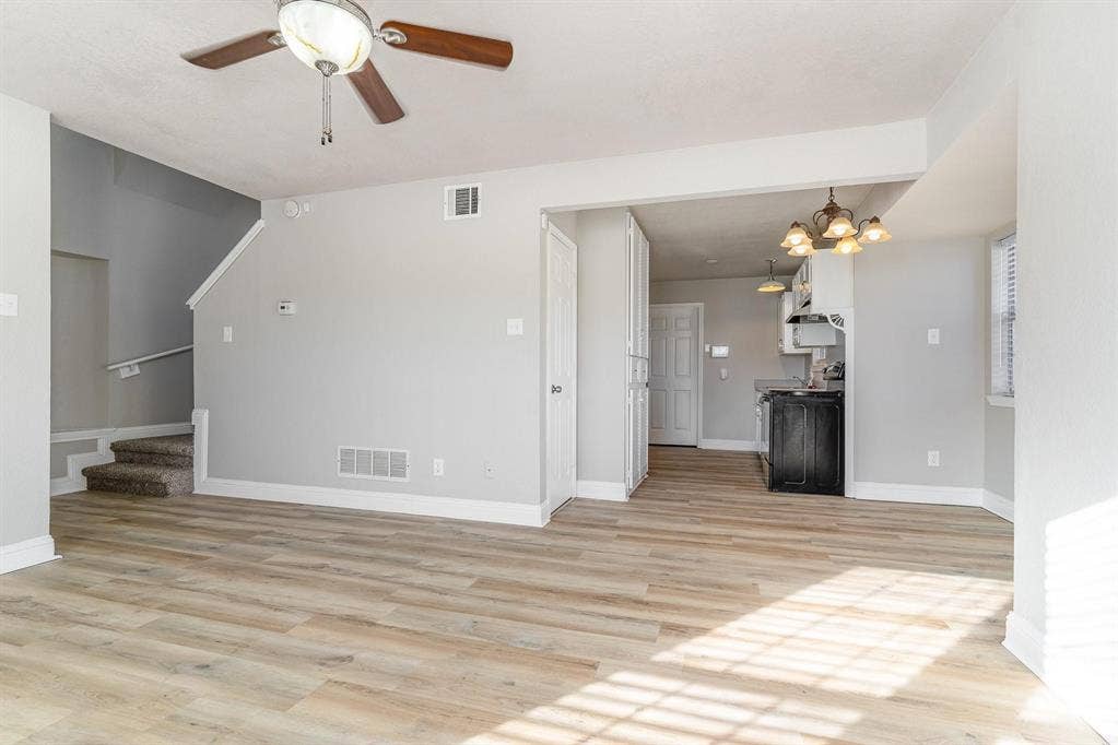 500 S Ballard Avenue, Wylie, TX 75098 Spacious living area featuring wood-finish flooring, a ceiling fan, and light gray wall paint