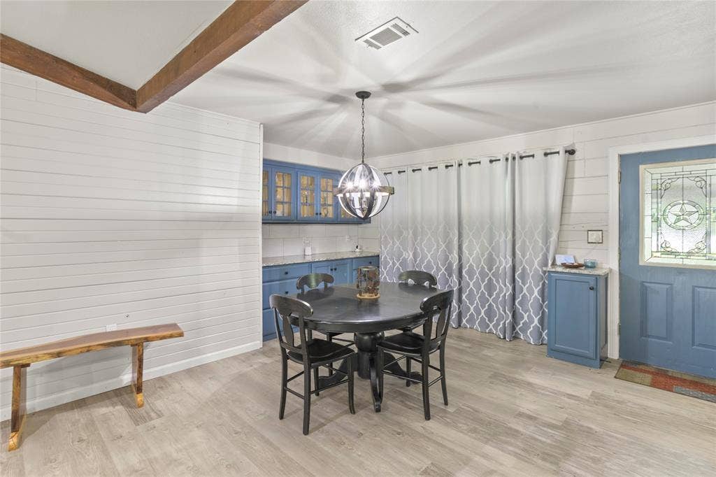 323 Dyer Circle, Payne Springs, TX 75156 Dining area featuring light wood-finish flooring, white shiplap walls, and exposed ceiling beams