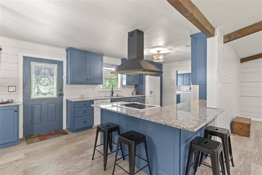 323 Dyer Circle, Payne Springs, TX 75156 Kitchen featuring blue cabinetry, light granite countertops, and a built-in electric cooktop with a range hood