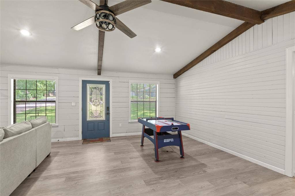 323 Dyer Circle, Payne Springs, TX 75156 Spacious room featuring wood-finish flooring, white shiplap walls, and exposed ceiling beams
