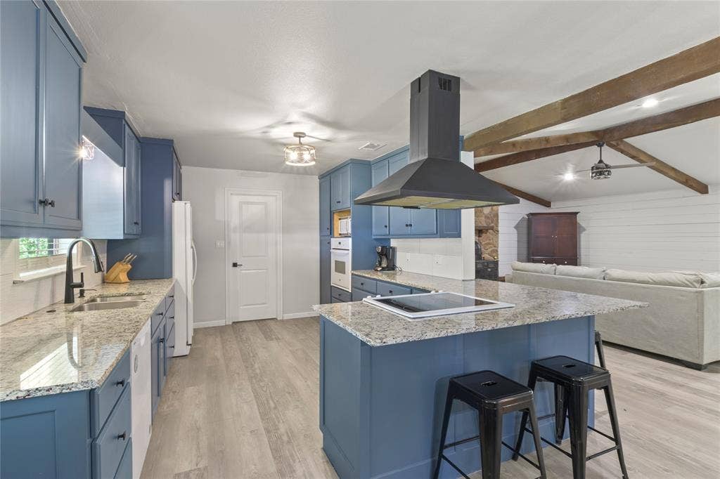 323 Dyer Circle, Payne Springs, TX 75156 Open-concept kitchen with blue cabinetry and granite countertops