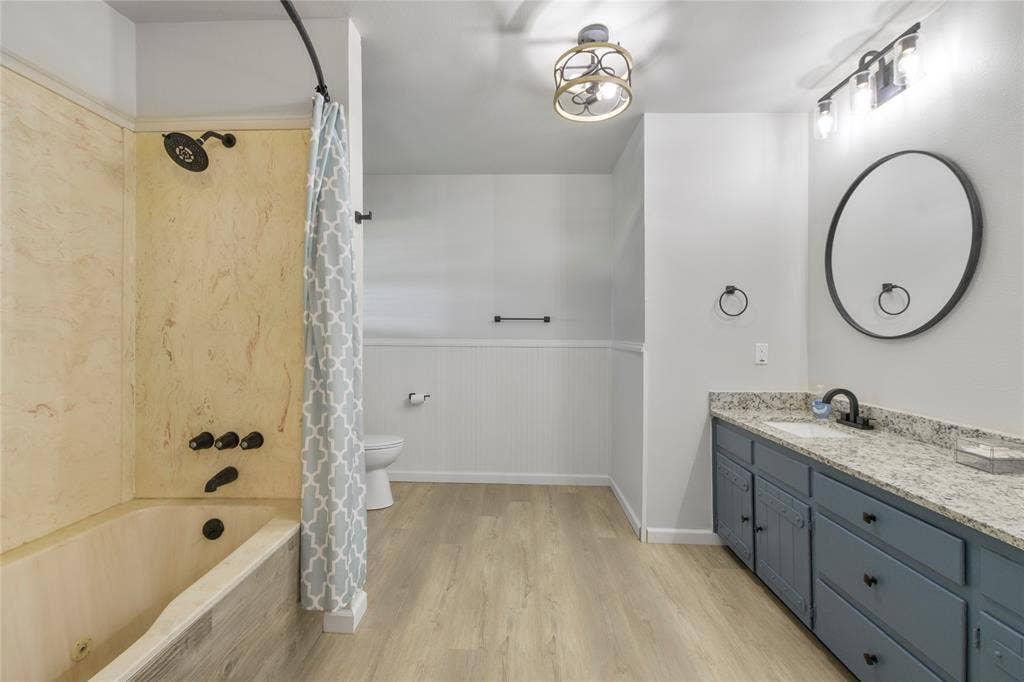 323 Dyer Circle, Payne Springs, TX 75156 Spacious bathroom featuring a full tub and shower with stone-look surround and black fixtures