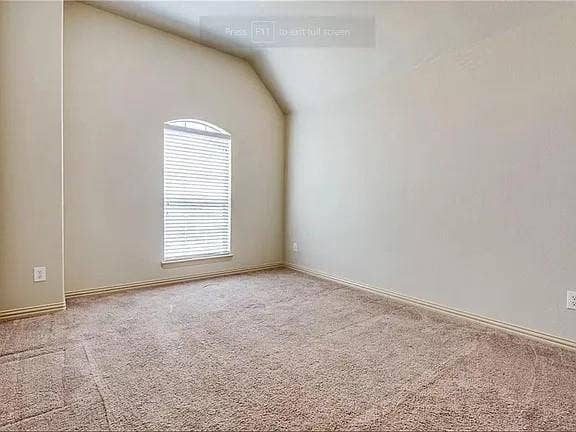 13990 Stevens Point Drive, Frisco, TX 75033 Vaulted ceiling room featuring a single arched window with blinds, neutral wall paint, light brown carpet, and matching baseboards
